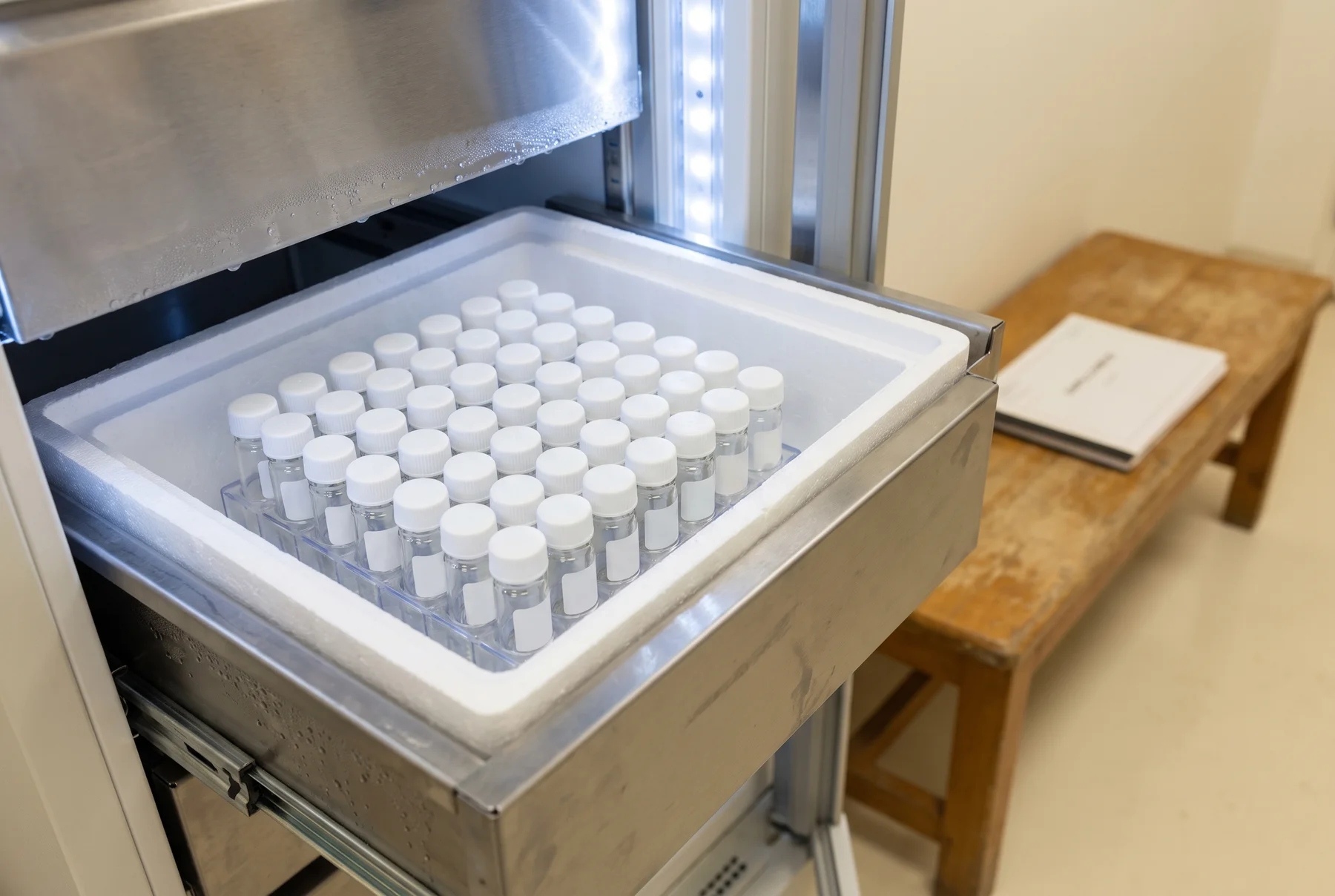 Conceptual illustration of blank sample tubes arranged in a laboratory cold storage compartment